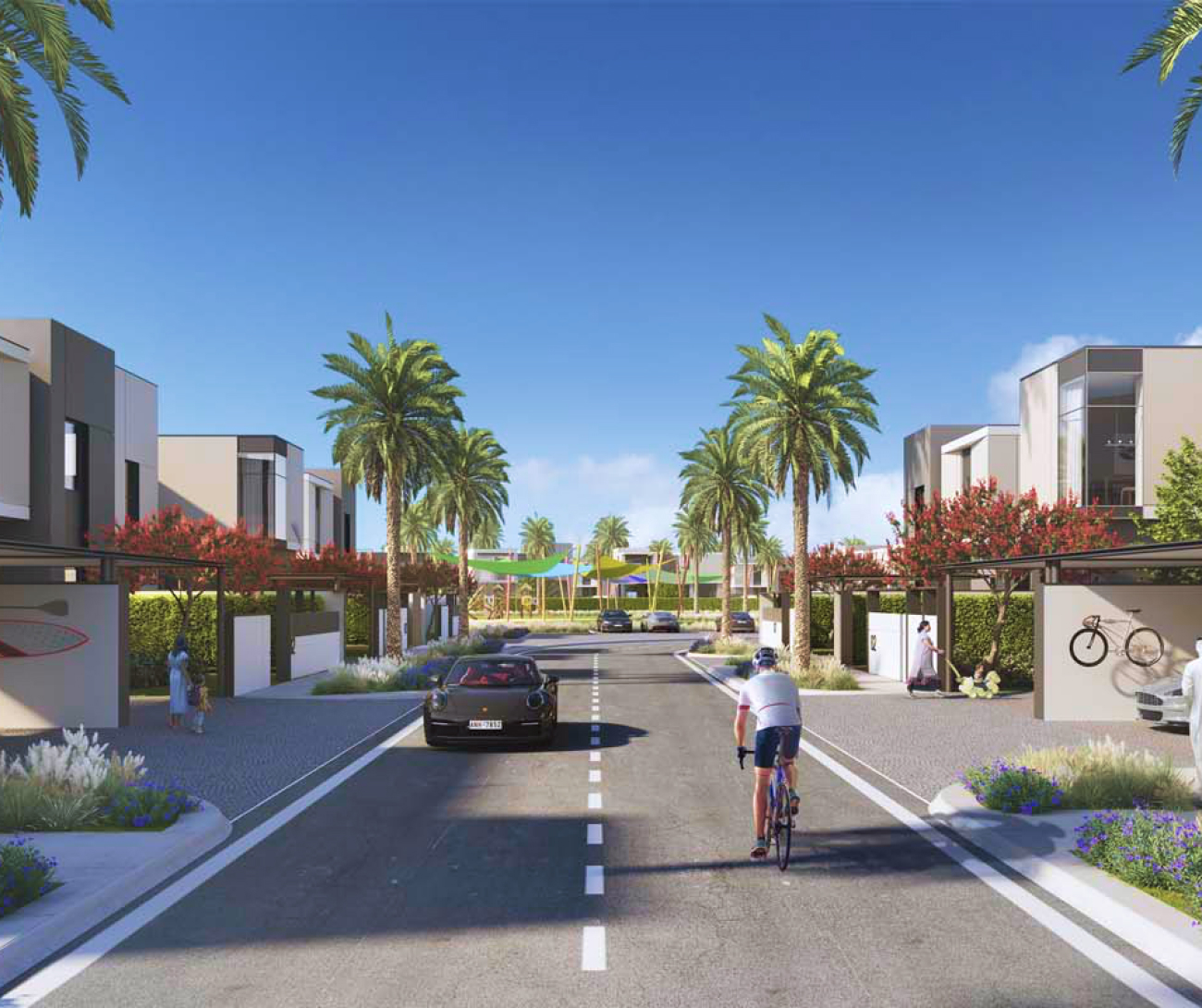 Communities A modern residential street lined with palm trees, colorful flowers, houses, and a cyclist riding on the road.