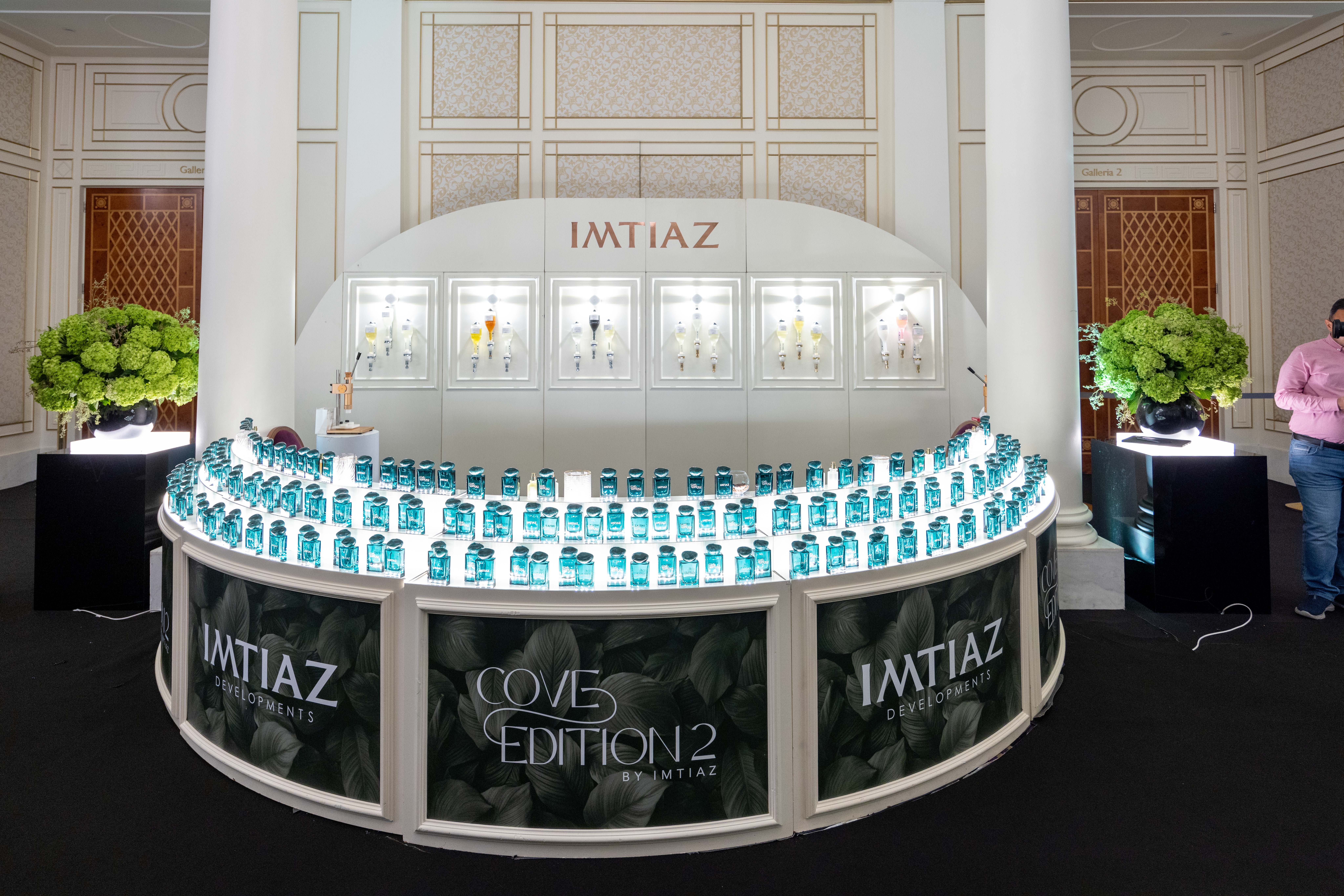 Events?Page=4 A decorative gift box with flowers and a ribbon, showcasing a small greenery-filled arrangement, labeled "IMTIAZ".