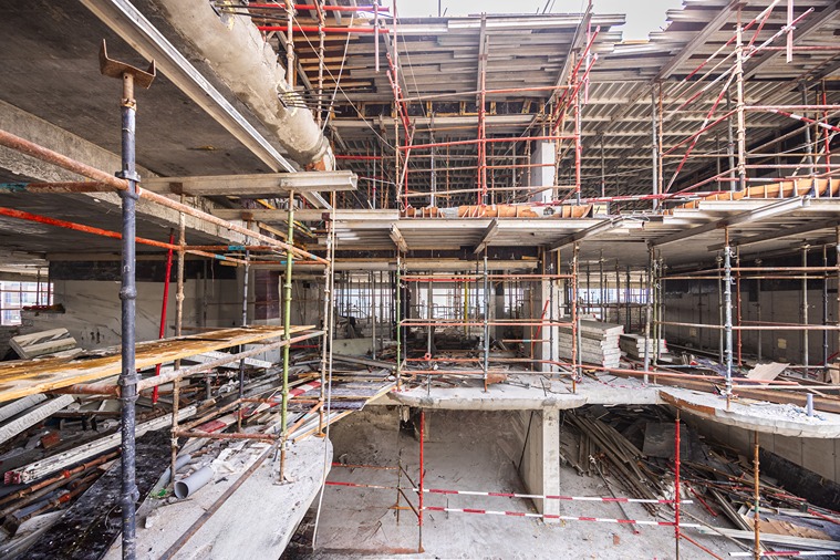 Pearl House By Imtiaz Construction site featuring scaffolding, unfinished concrete structure, and construction materials scattered throughout.
