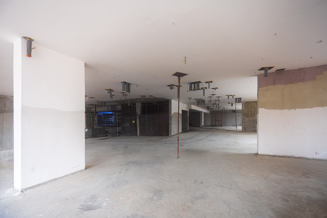 Pearl House By Imtiaz A spacious, empty interior under construction, featuring exposed beams, columns, and unfinished walls.