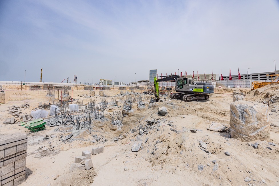 Beach Walk Residence Construction site featuring heavy machinery, tools, and unfinished structures under a clear blue sky.