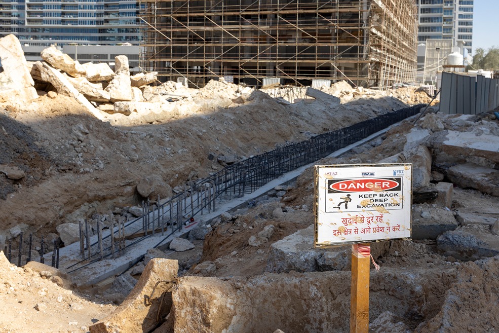 Cove Edition I By Imtiaz 1 Construction site featuring a deep excavation area with a warning sign to keep back from the site.