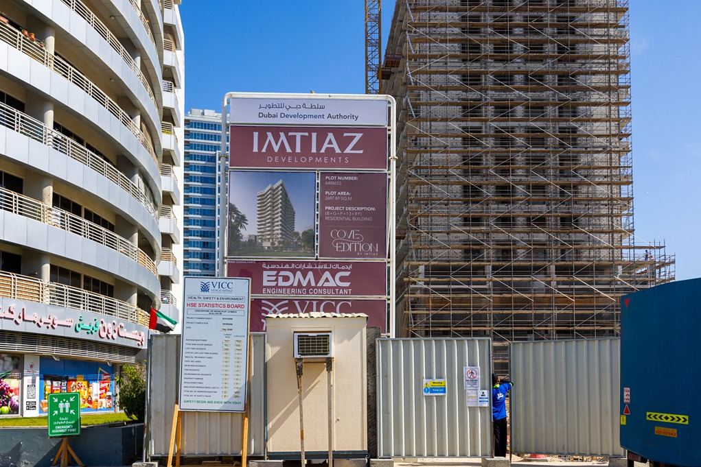 Cove Edition I By Imtiaz 1 Construction site featuring a large development sign for Imtiaz Developments and scaffolding around a building.