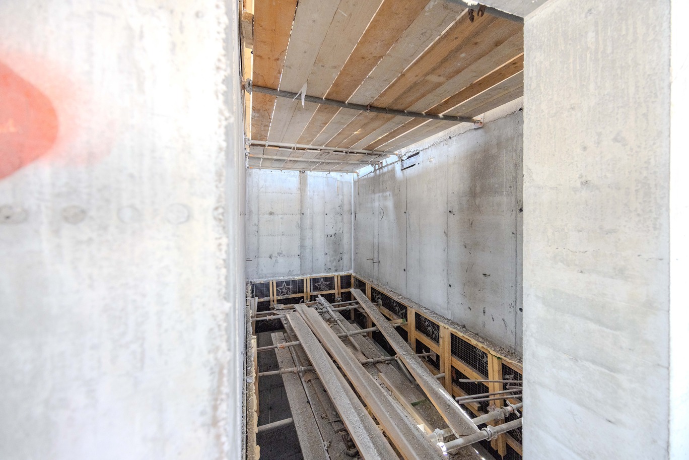 Beach Walk Iii By Imtiaz Interior of a construction site showing concrete walls, exposed beams, and supporting structures.