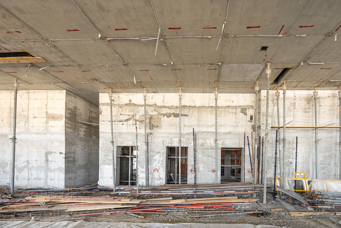 Beach Walk Iii By Imtiaz An unfinished interior of a building under construction, featuring exposed concrete walls and scaffolding.