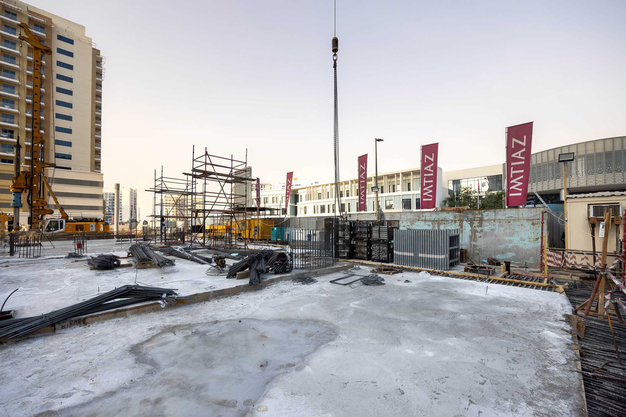 Cove Edition I By Imtiaz 1 A construction site with scaffolding, steel beams, and machinery, showcasing ongoing development.