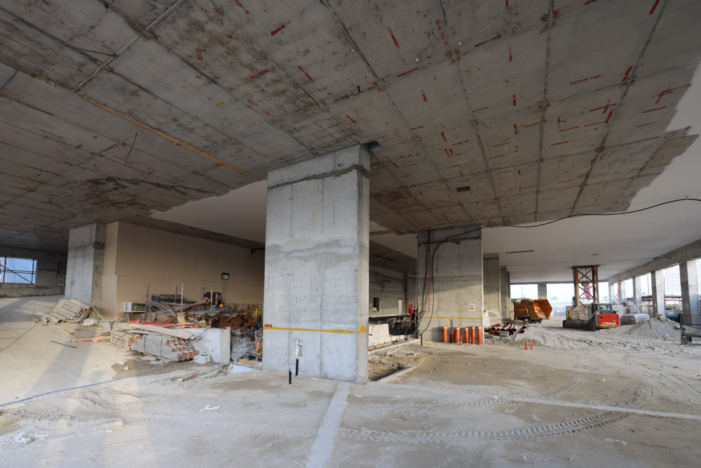 Beach Walk Iii By Imtiaz An unfinished construction site featuring concrete pillars, exposed beams, scattered materials, and unfinished floors.