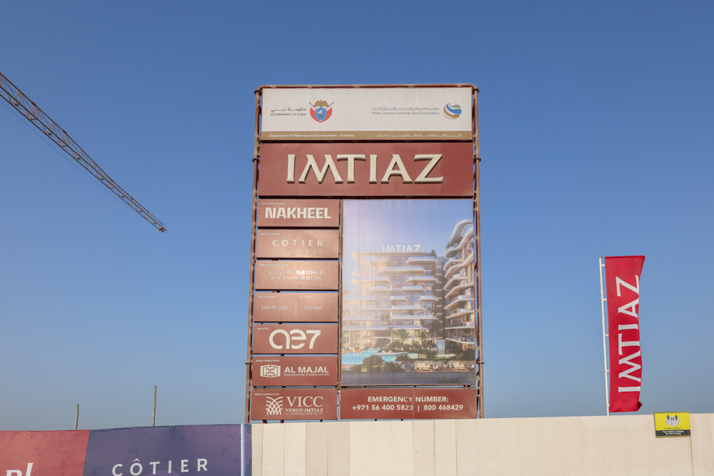 Cotier House 2 By Imtiaz A large billboard displaying the name "IMTIAZ" with various logos and details about properties like Nakheel and Cotier.