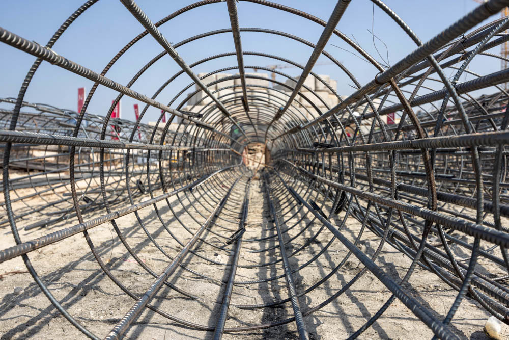 Cotier House 2 By Imtiaz A construction site featuring a series of steel reinforcement bars arranged in circular patterns on the ground.