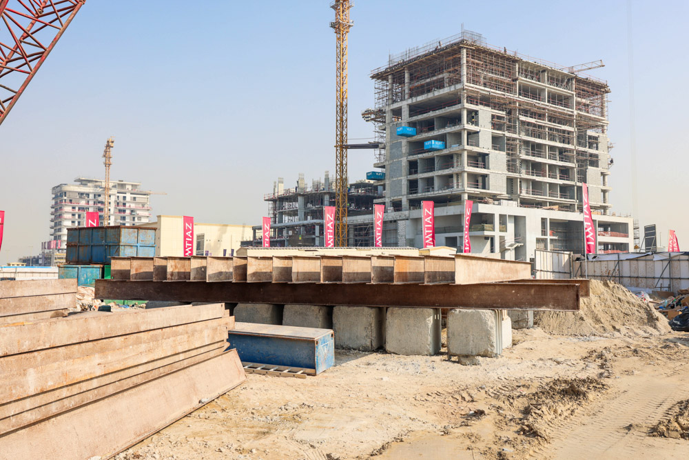 Cotier House 2 By Imtiaz Construction site with large beams, cranes, and scaffolding for a multi-story building under development.