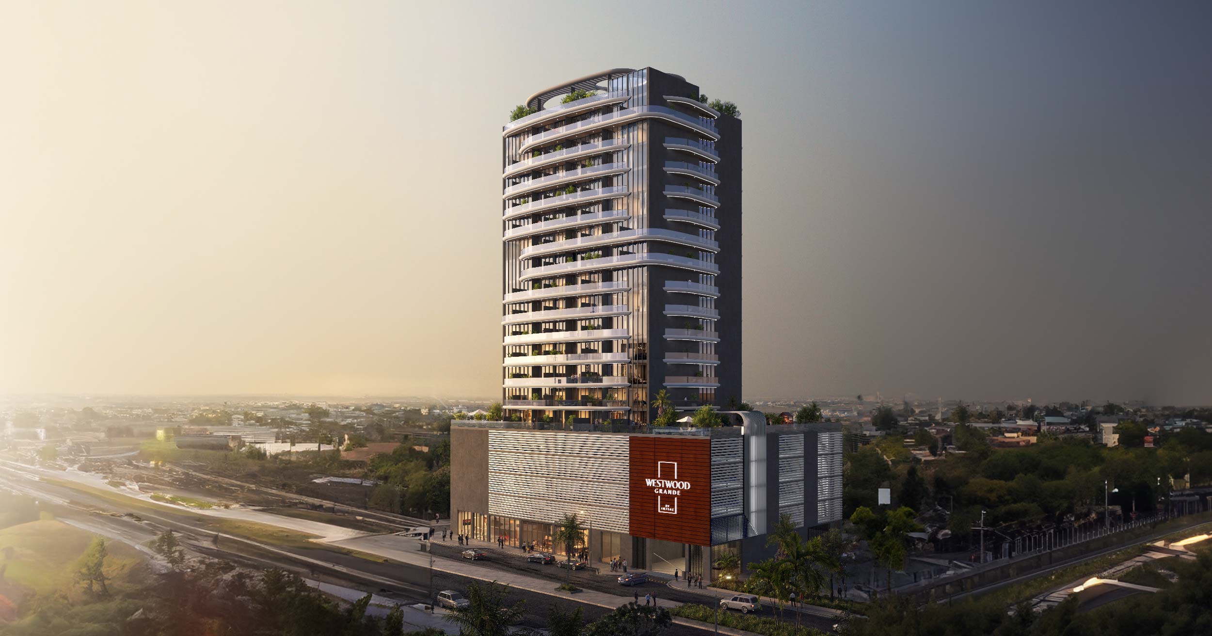 Westwood Grande By Imtiaz A modern, multi-story building with green terraces and a sign reading "Westwood Grande" in a city landscape.