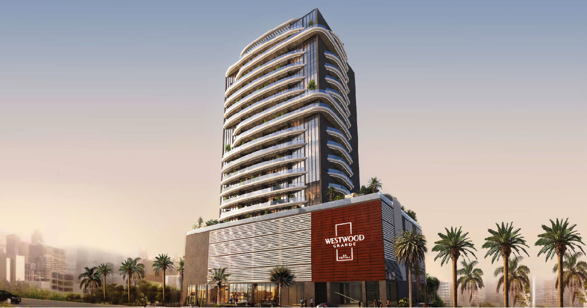 Westwood Grande By Imtiaz A modern, multi-story building with a sleek design featuring balconies, greenery, and palm trees surrounding it.