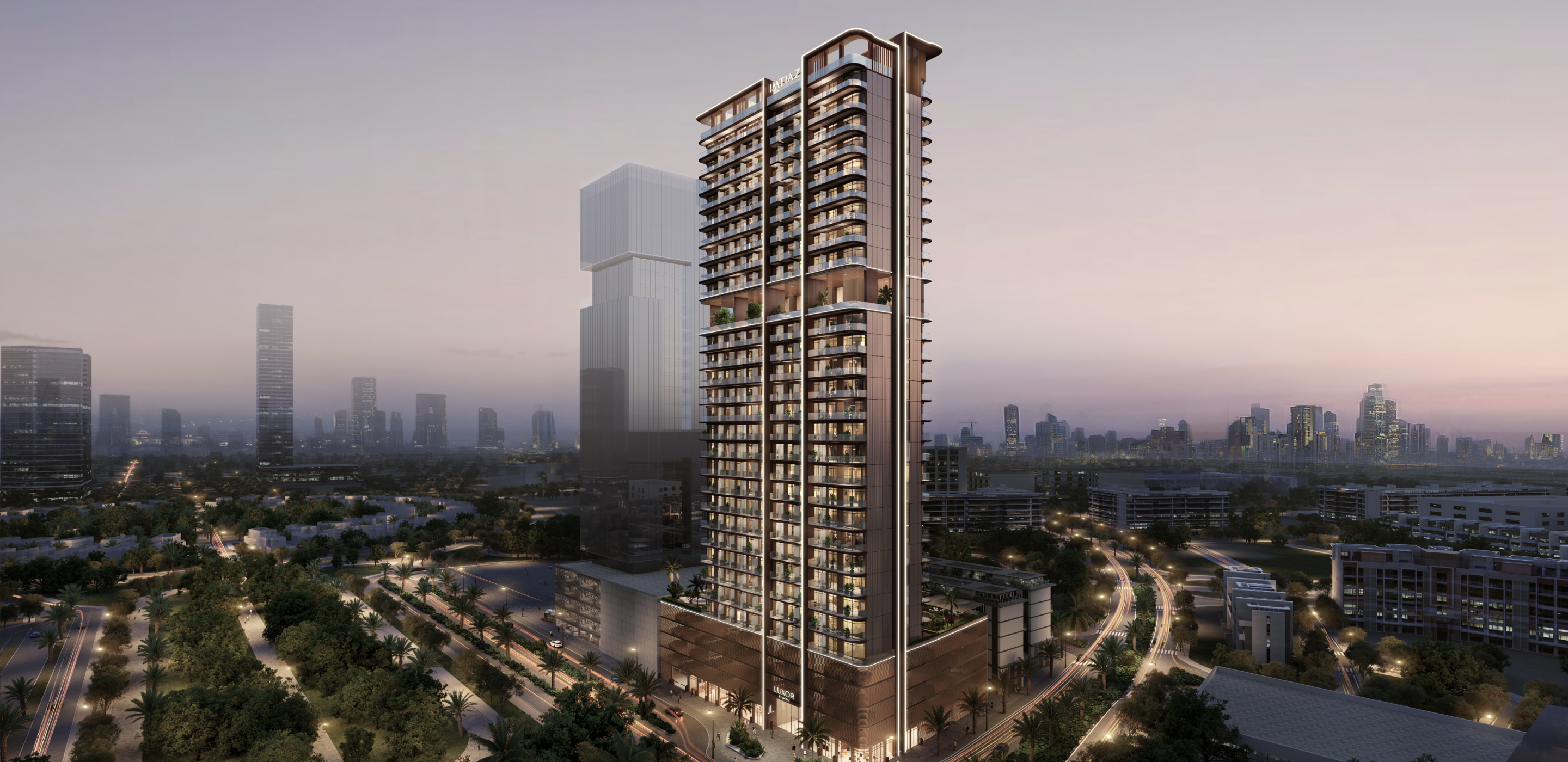 Luxor By Imtiaz A modern residential tower at dusk, surrounded by greenery and city skyline in the background, showcasing urban living.