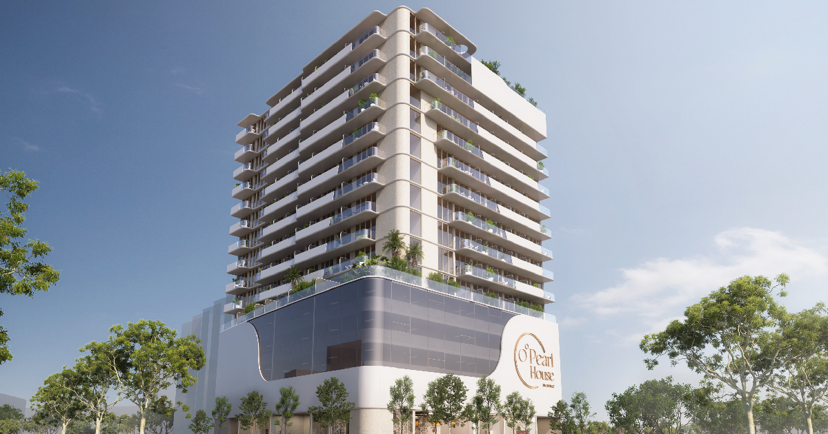 Pearl House By Imtiaz Modern residential building with balconies and greenery, showcasing a sleek design and clear blue sky.
