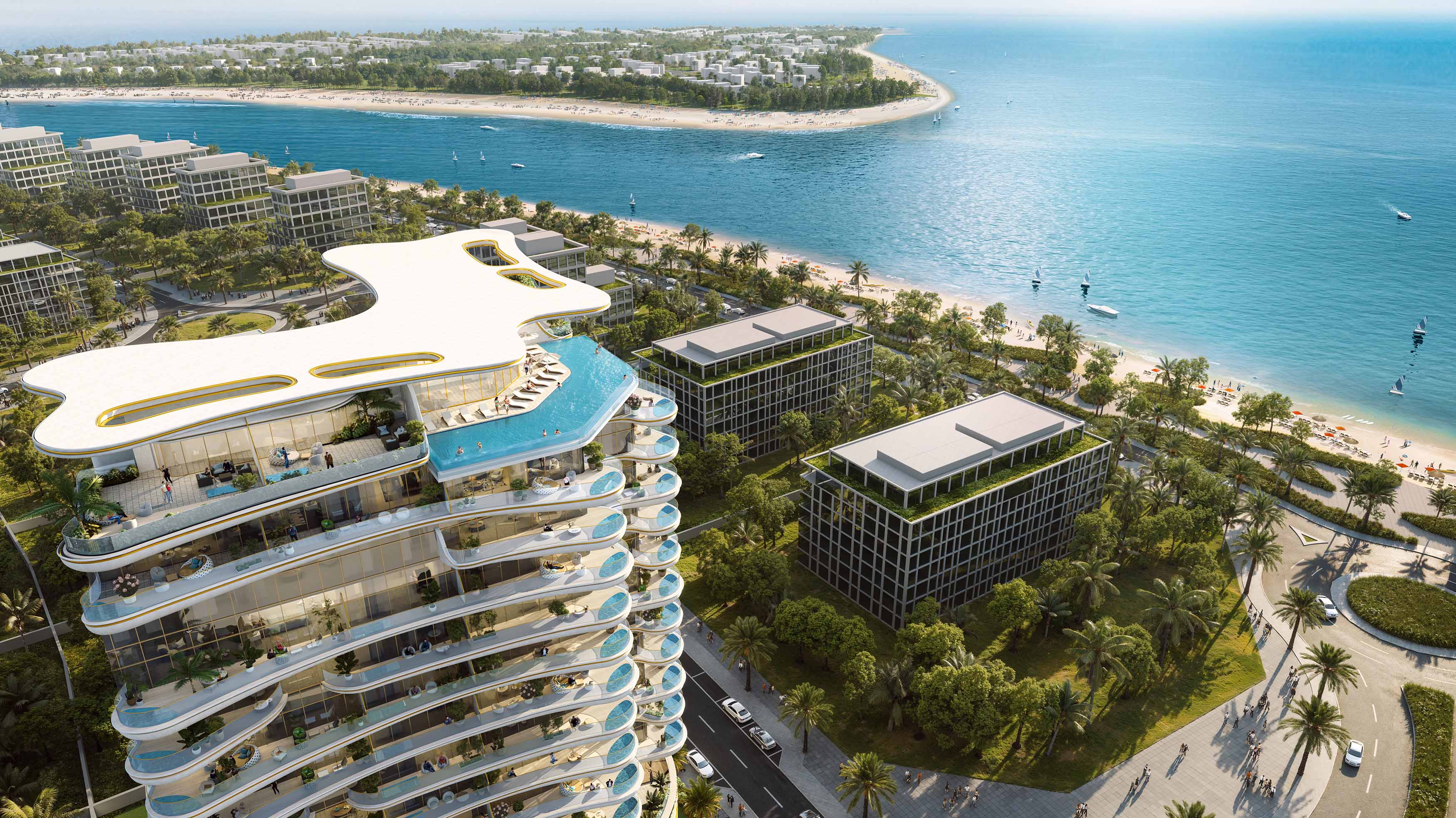Beach Walk Grand By Imtiaz Aerial view of modern beachside buildings, lush greenery, and a serene shoreline with boats on the water.