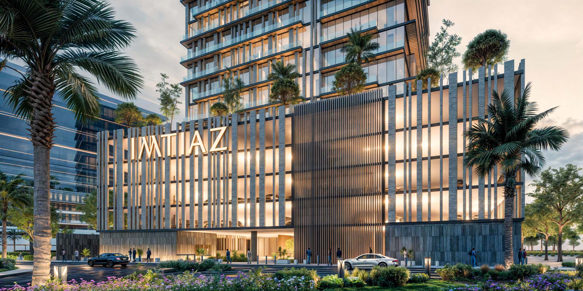 Cove Boulevard By Imtiaz A modern building with glass facades, greenery, palm trees, and a welcoming entrance in an urban setting.