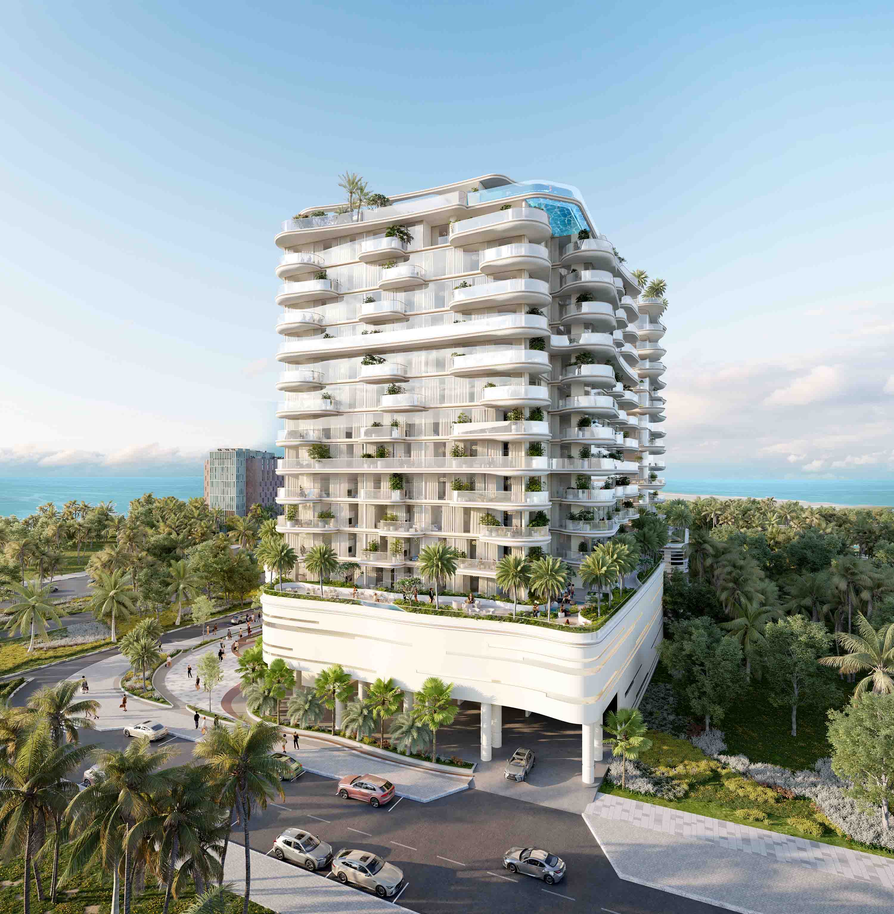 Beach Walk Grand 2 By Imtiaz A modern, multi-story building surrounded by palm trees, with vehicles and pedestrians on a scenic coastal road.