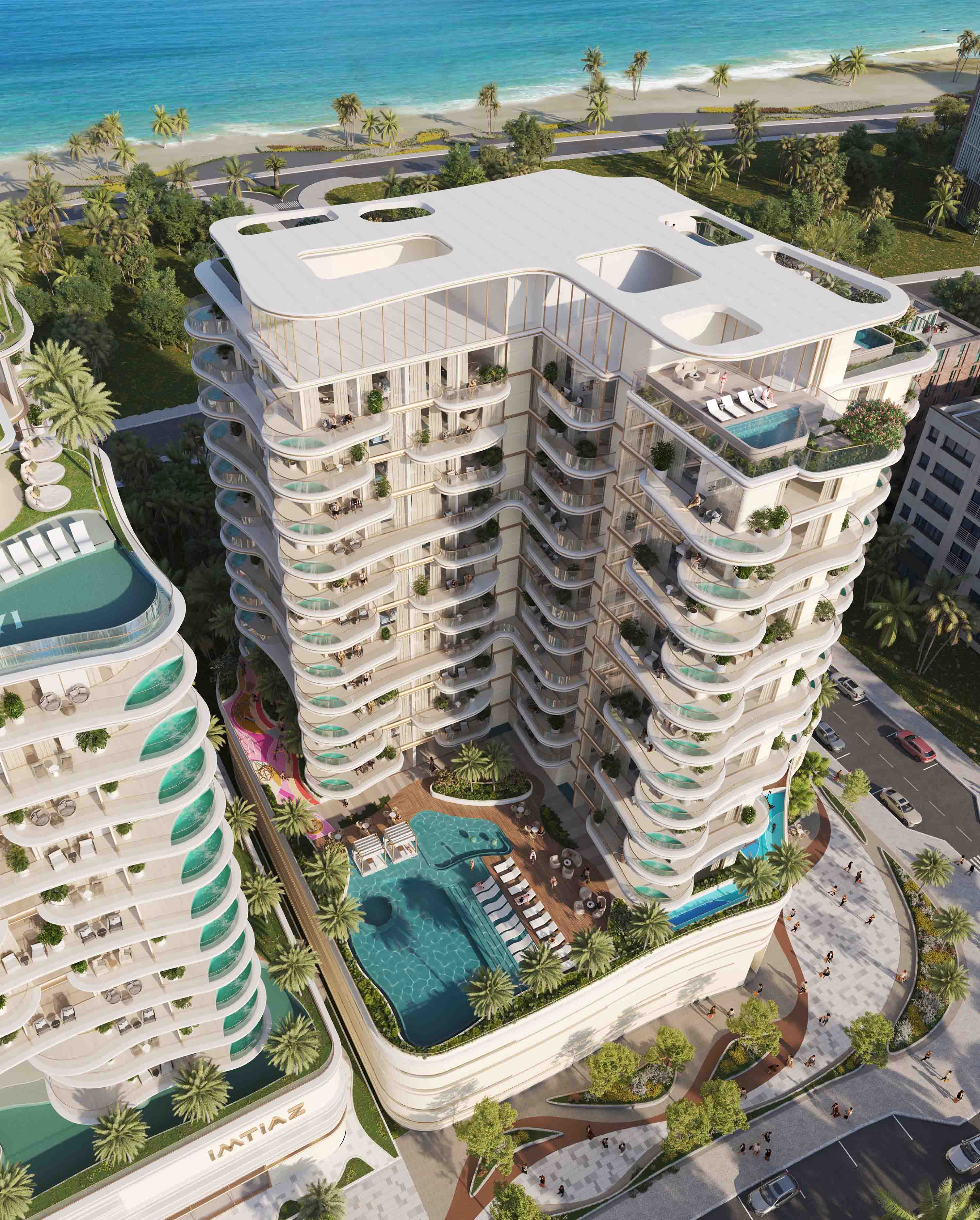 Beach Walk Grand 2 By Imtiaz A modern beachfront residential building with balconies, pools, and lush greenery, overlooking the ocean.