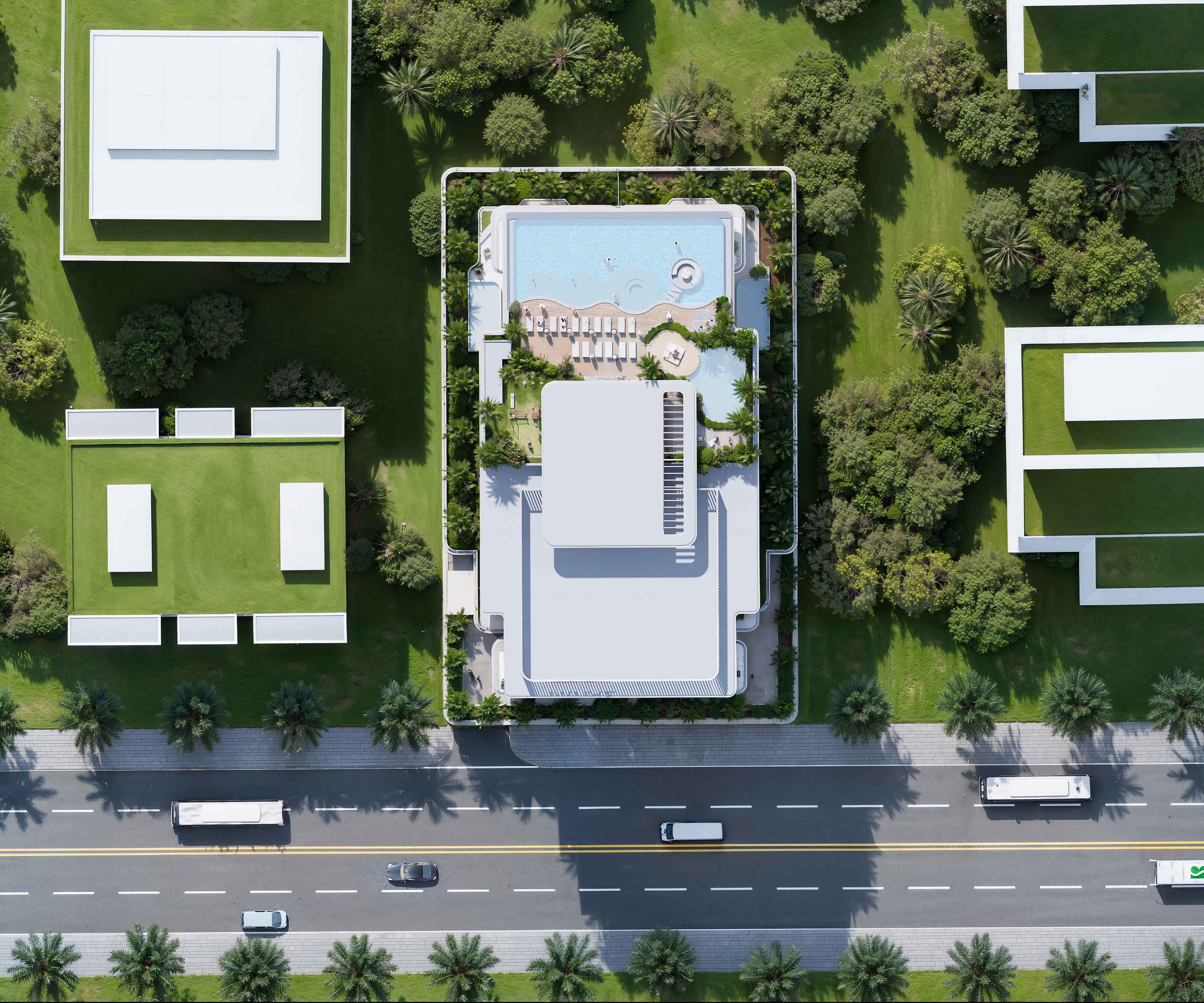 Sunset Bay 5 By Imtiaz Aerial view of a modern building complex with a swimming pool and landscaped gardens, surrounded by a road.