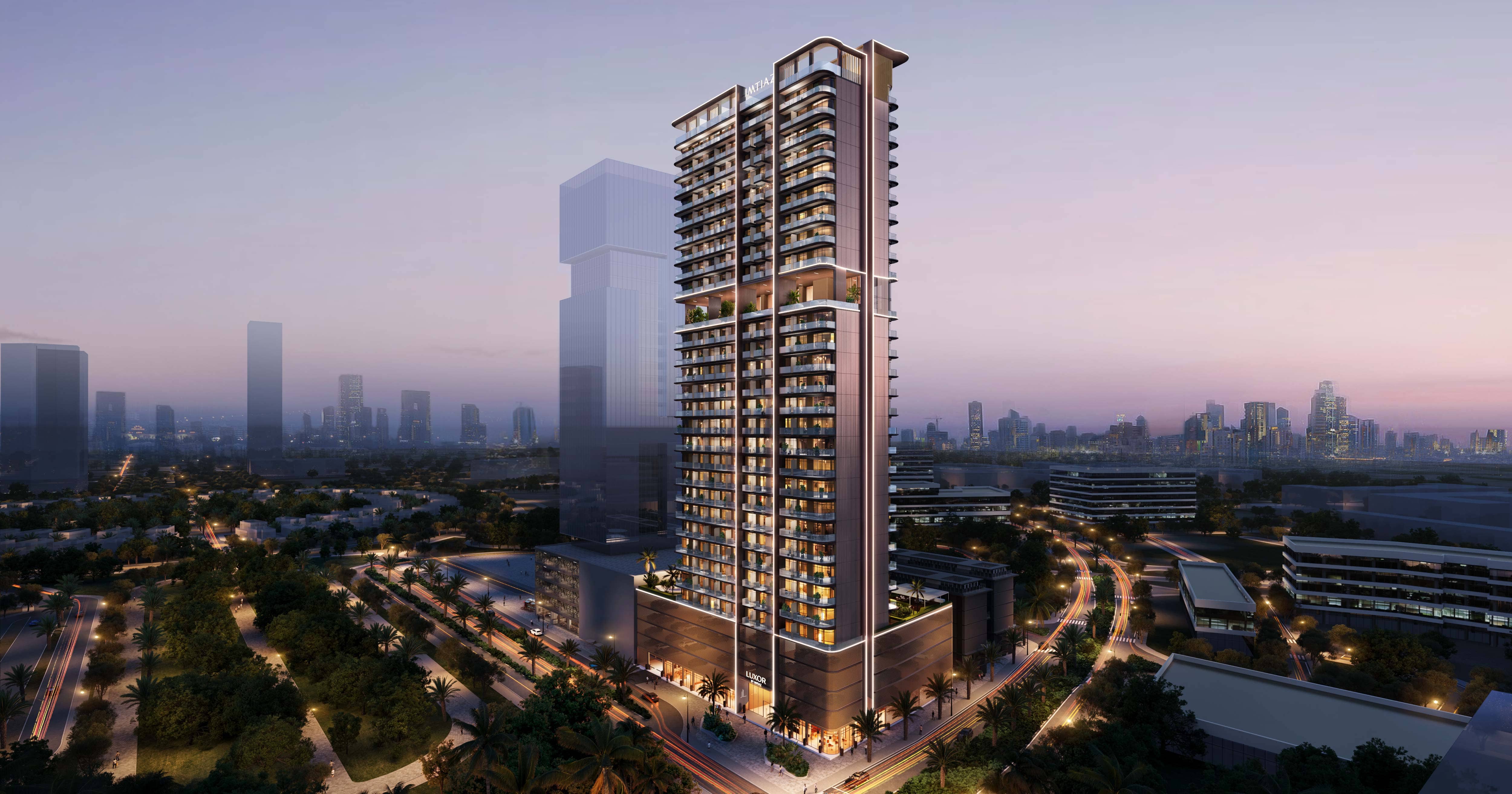 Luxor By Imtiaz A modern skyscraper with balconies, surrounded by greenery and city skyline at dusk, showcasing urban architecture.