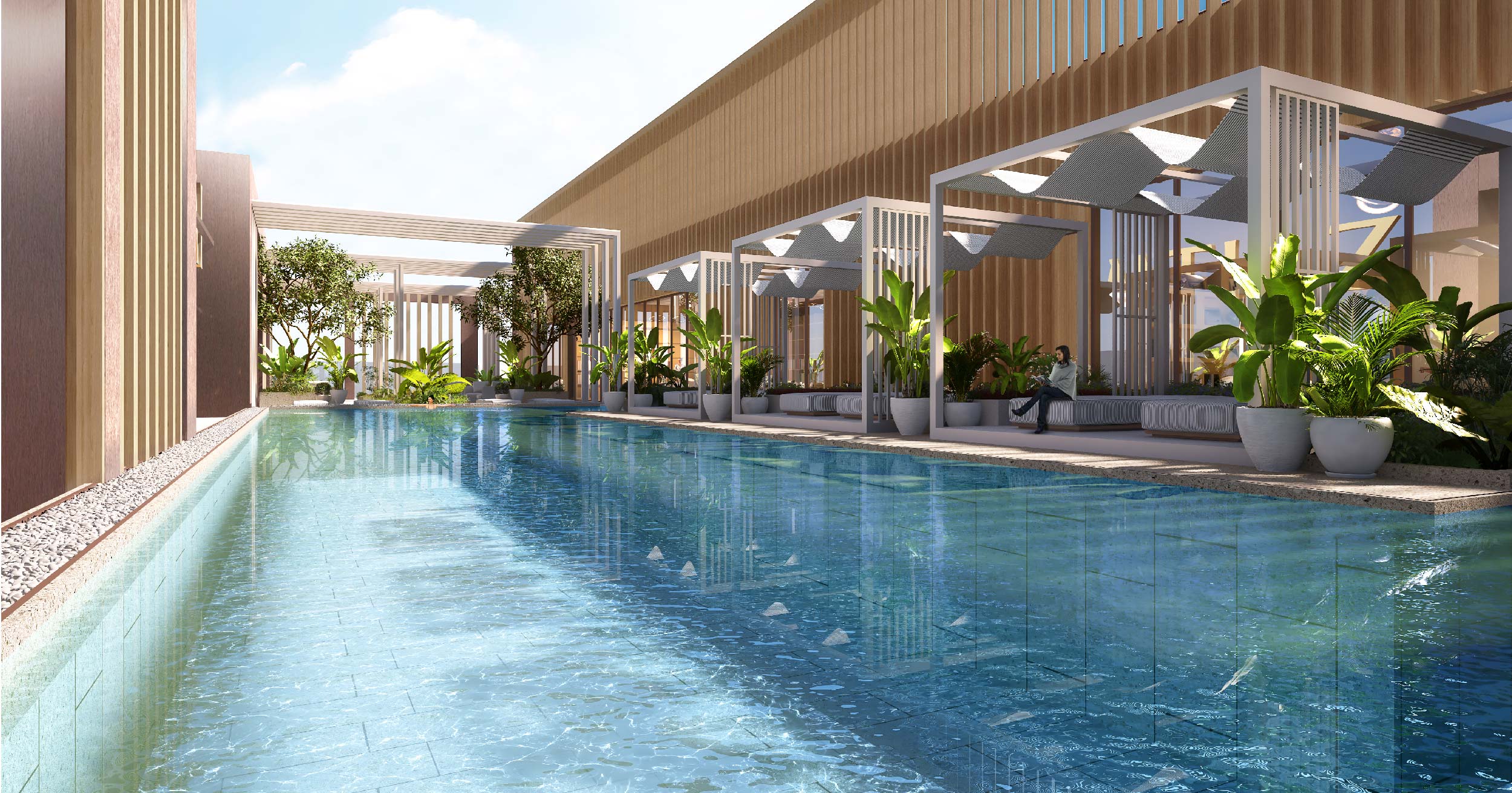 Luxor By Imtiaz A serene pool area with lush plants, shaded seating, and modern architecture under a clear blue sky.