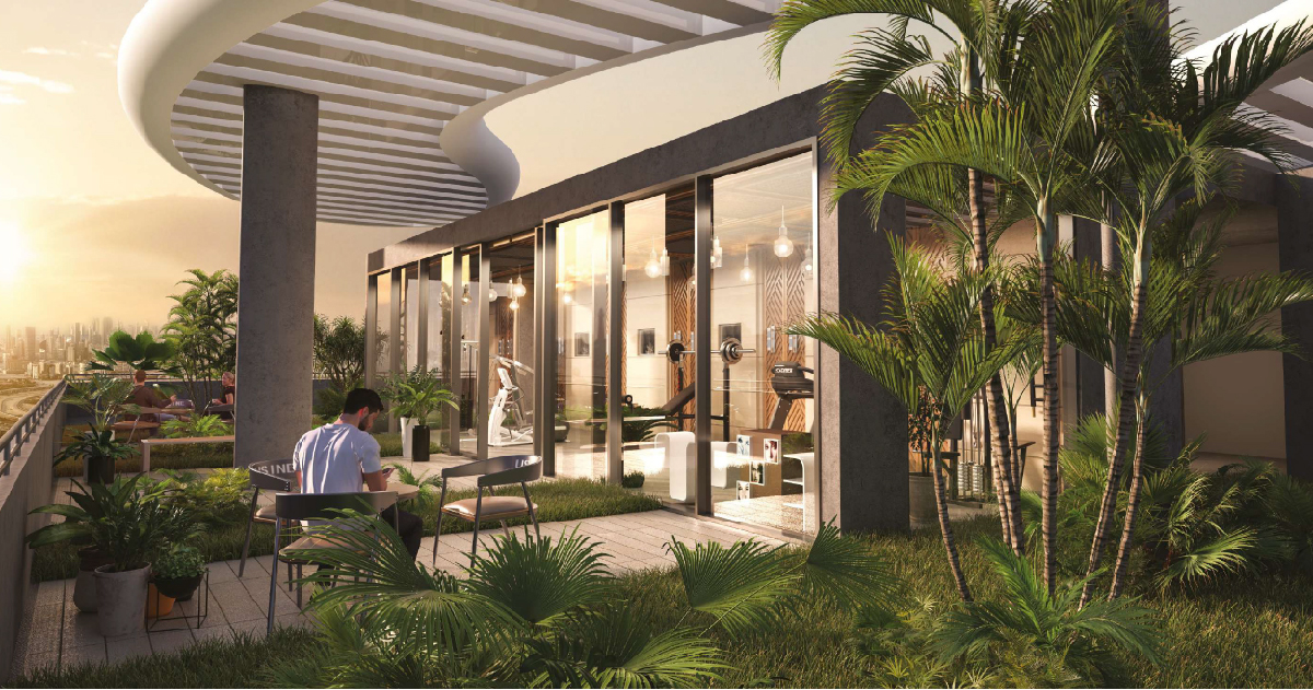 Westwood Grande Ii By Imtiaz A modern outdoor space featuring a gym area, a man working at a table, plants, and a sunset backdrop.