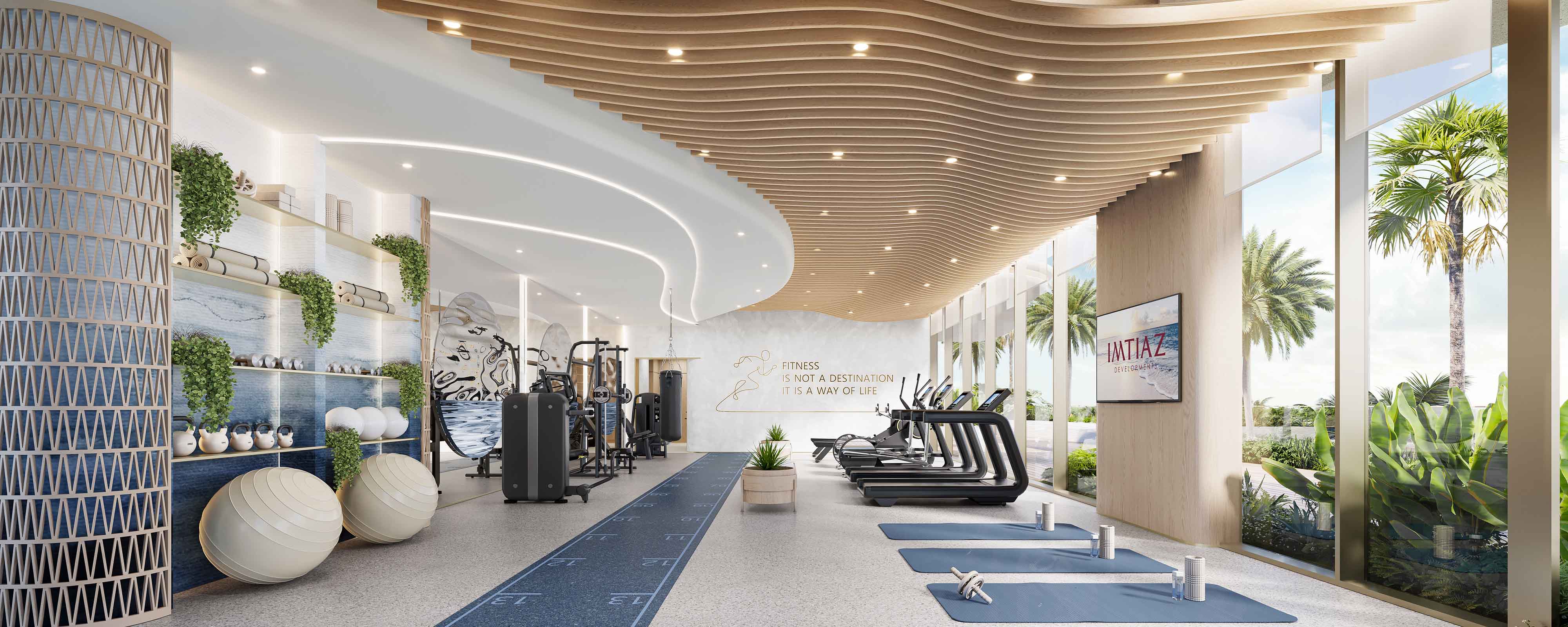 Beach Walk 4 By Imtiaz Modern gym interior featuring workout equipment, yoga mats, and large windows with tropical plants outside.