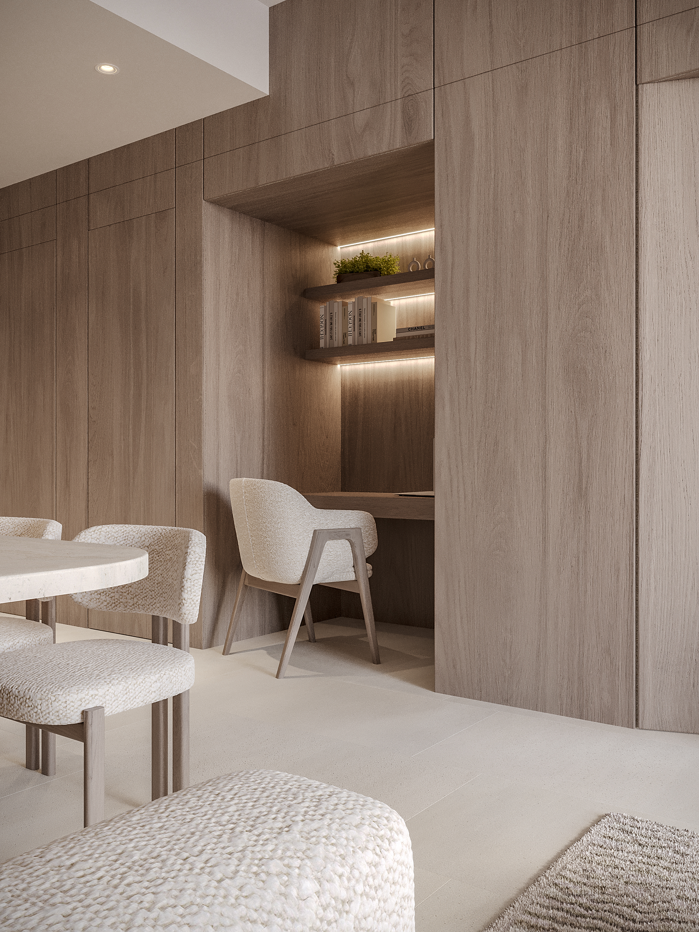 Pearl House Ii By Imtiaz A modern interior featuring a wooden wall, a cozy workspace with a chair, and stylish, textured seating.