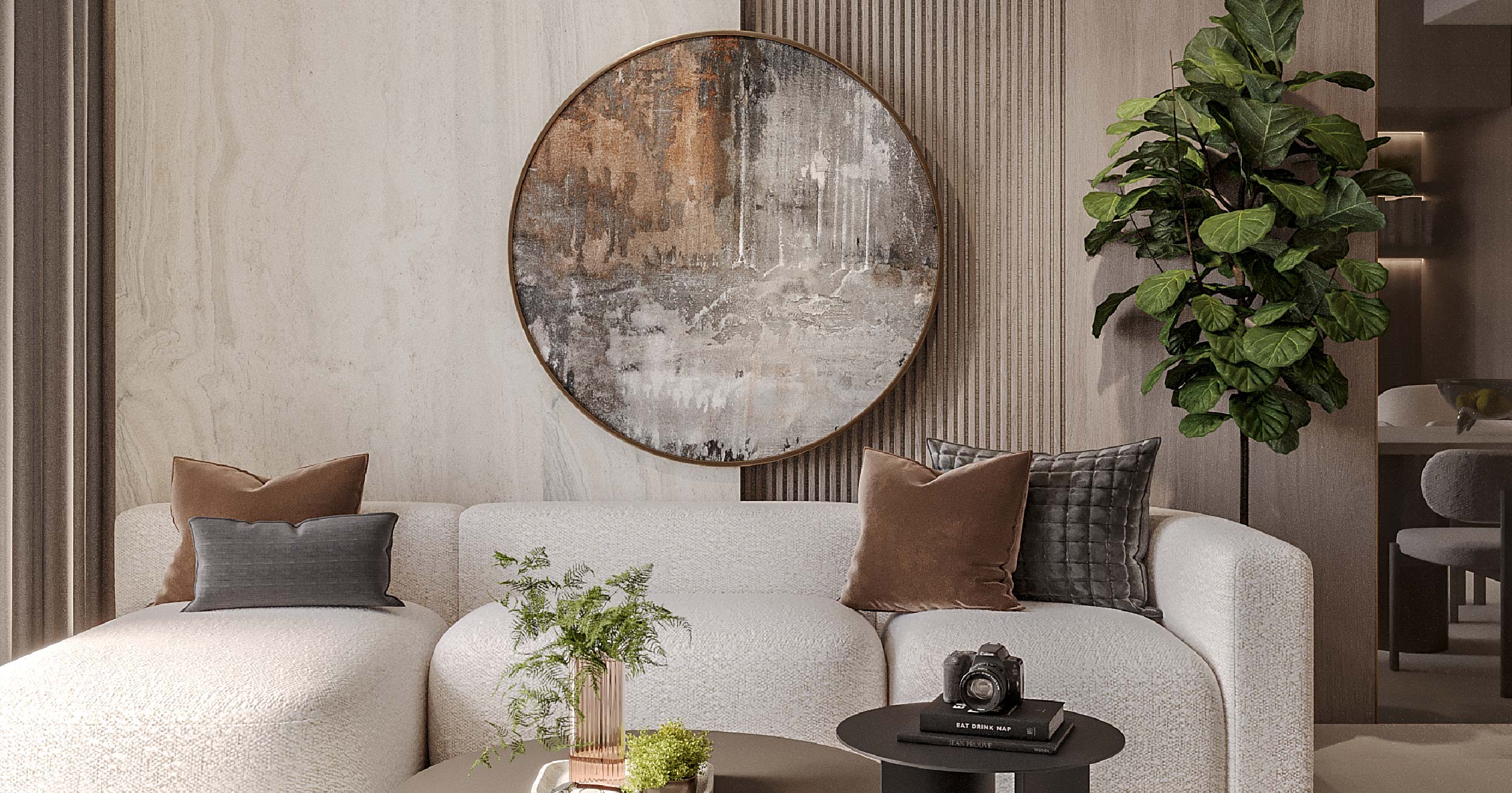 Pearl House By Imtiaz A modern living space featuring a curved sofa, decorative pillows, a round wall art piece, and a potted plant.
