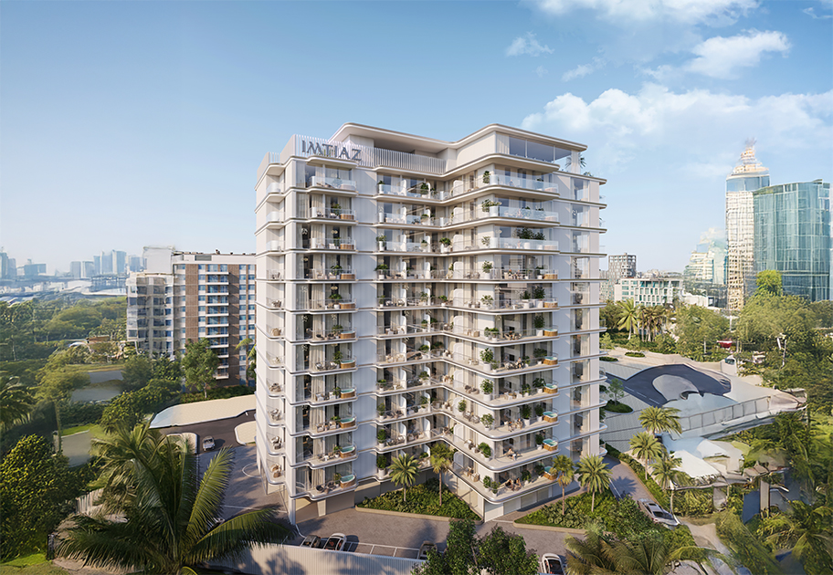 Properties A modern multi-story residential building surrounded by greenery and other structures, under a clear blue sky.